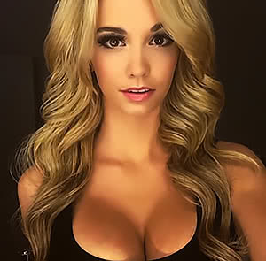 Pretty Caitlin Arnett poses and demonstrates her tits