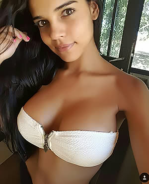 Spicy beauty Daniela Baptista poses and demonstrates her big tits