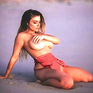 Jem Wolfie poses topless on the beach